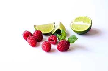 A fragrant bunch of raspberries with juicy lime for healthy cooking.
