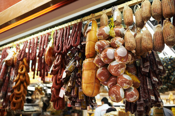 Hooks, butcher and dry meat in shop for traditional food, groceries or products in Germany....