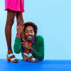 Couple, studio and smile with color, fashion and love with relationship and begging. African man,...