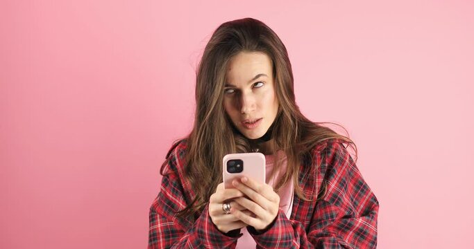 Shock, omg angry woman with phone on pink background for notification, announcement and fake news. Surprised, mad portrait of female person with wtf face for social media, gossip and online post.