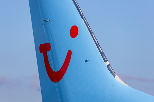 Salzburg, Austria - January 27, 2024: TUI company logo on the tail of a TUI airlines charter airplane