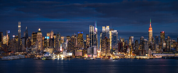 New York City panoramic view at dusk from the Hudson River. The view includes the skyscrapers of...