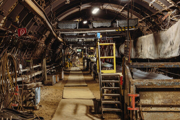 Coal mining underground with large machines and in long, dark corridors and tunnels 