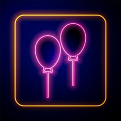 Glowing neon Balloons with ribbon icon isolated on black background. Vector