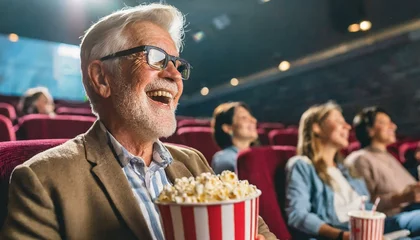 Keuken spatwand met foto senior person watching a movie in the cinema having fun  old man at the cinema eating popcorn © Hanna
