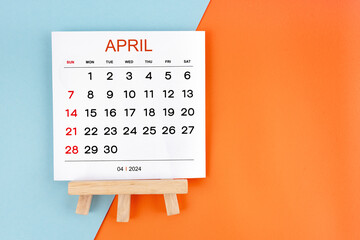2024 April calendar page on blue and orange background.