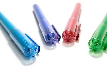 Close-up of colorful pen lids with a small hole to prevent choking 
