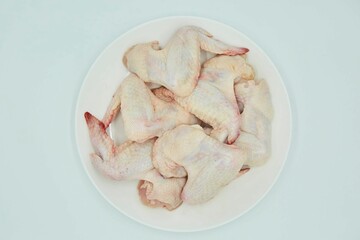 Raw meat chicken wings on a white background. Different parts of meat products for different dishes.