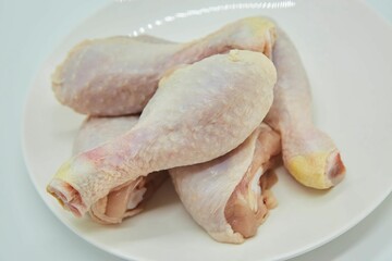 Raw meat chicken legs on a white background. Different parts of meat products for different dishes.
