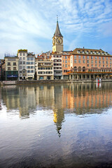 Fototapeta na wymiar buildings of the historic center of the city of Zurich along the Limmat river, clock tower of the St. Peter church. 