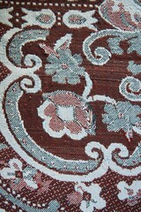 The texture of the old tapestry fabric is red with a pattern