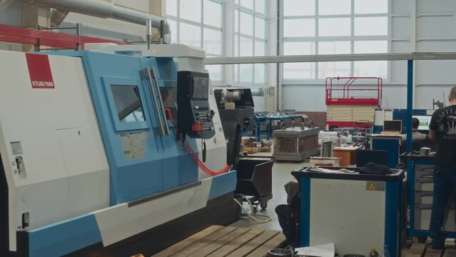 Modern CNC lathe machine and other professional equipment at metalworks factoryModern CNC lathe machine and other professional equipment at metalworks factory