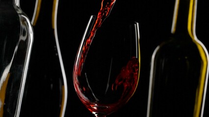 Elegant Red Wine Pouring into Glass Against Dark Background