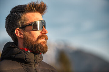 A young man with a beard and sunglasses - 748803268
