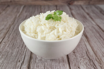 White rice in bowl on wood table