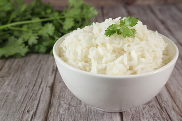 White rice in bowl on wood table
