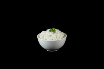 White rice in bowl, black background