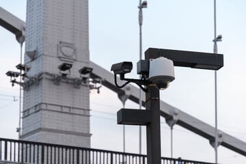 CCTV cameras against the background of the metal structures of the bridge.