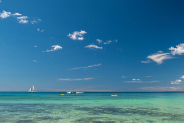 Seascape with crystal clear turquoise water, yachts, boats and people kayaking. South destination,...