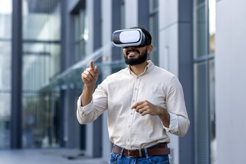 Young bearded man enjoying a virtual reality experience outdoors