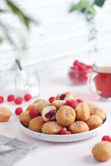 A plate wit traditional berliner cakes with jelly