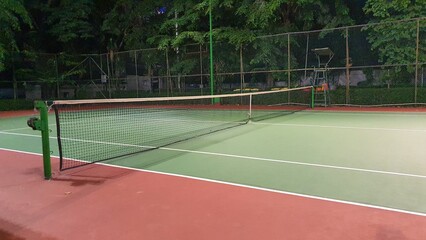 Tennis court and net at night - obrazy, fototapety, plakaty