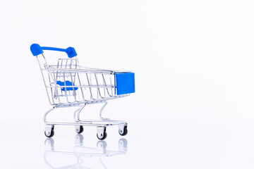 Shopping trolley, supermarket trolley on a white background. Copy space.