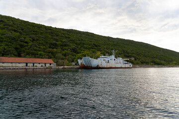 Old, rusty, decommissioned warships off the coast of the adriatic sea
