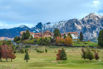 Autumn Season at Mountain Lodge with Golf Course and Snow-Capped Peaks