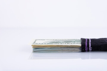 Money sock. a bundle of American hundred dollar bills hidden in a sock. Savings and storage...