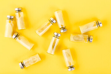 Bubbles, ampoules with dry probiotic, bifidobacteria, with probiotic powder inside on a yellow...