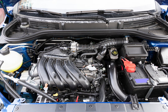 Clean engine compartment of a brand new car, with an engine capacity of 1600 millimeters.