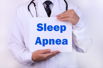 Doctor holding a card with Sleep Apnea medical concept