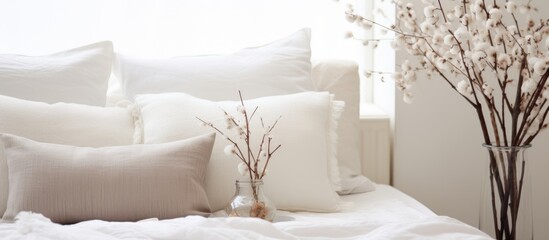 A white bed with a matching comforter and pillows neatly arranged. The pillows are fluffy and comfortable, adding a touch of elegance to the bedroom decor.