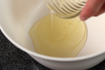 Pouring egg whites into bowl