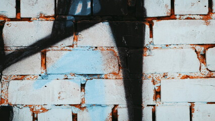 Graffiti Title on White Brick Wall