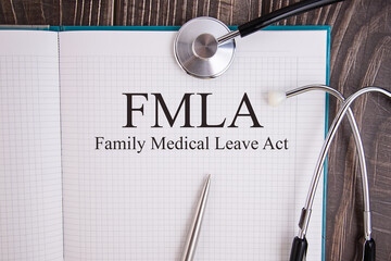 Page with, FMLA, Family Medical Leave Act on the table with stethoscope, medical concept