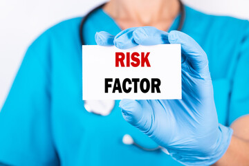 Doctor holding a card with text RISK FACTOR, medical concept