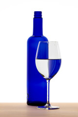 A blue Bottle with a wine glass