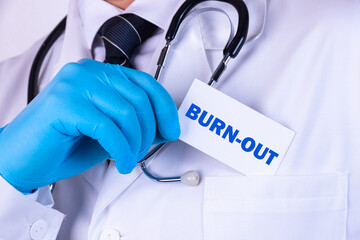 Doctor holding a card with text Burn-out medical concept - obrazy, fototapety, plakaty
