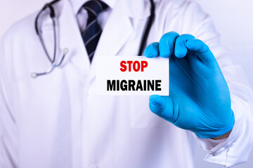 Doctor holding a card with text Stop migraine medical concept