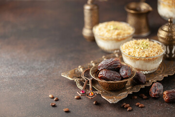 Dry dates, crispy Ramadan dessert custard pudding with roasted kadayif and cup of coffee  for iftar time. Islamic religion and ramadan concept.
