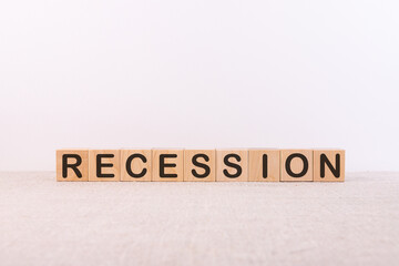 Word RECESSION is made of wooden building blocks lying on a light background.