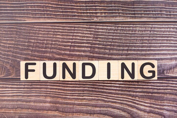 FUNDING word made with wood building blocks.