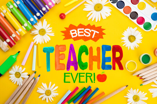 Childish lettering for Teachers' Day. Appreciation of teachers top view flat lay concept. Colored paper, multi-coloured letters, supplies