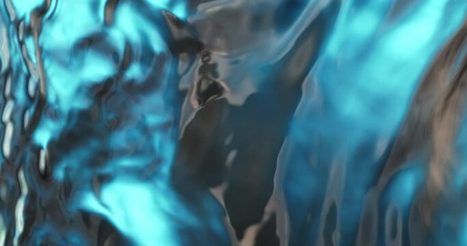 Super slow motion macro of transparent pure clear crystal water surface with moving waves on light blue background. Filmed on high speed cinema camera at 1000 fps.