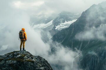 Mountaineer overlooking a foggy mountain range.