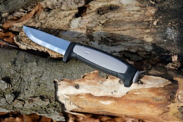 Scandinavian knife in the forest on a wooden background