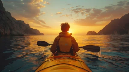Foto auf Acrylglas young man rowing kayak in the sea at sunset © fajar
