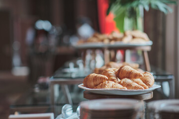 many croissants in many trays awaited to be served to the business conference attendees during the...